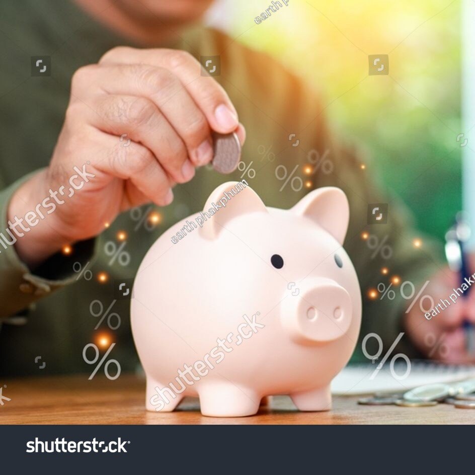 stock-photo-concepts-of-saving-money-and-financial-planning-man-hand-holding-piggy-bank-on-wood-table-income-2486598689