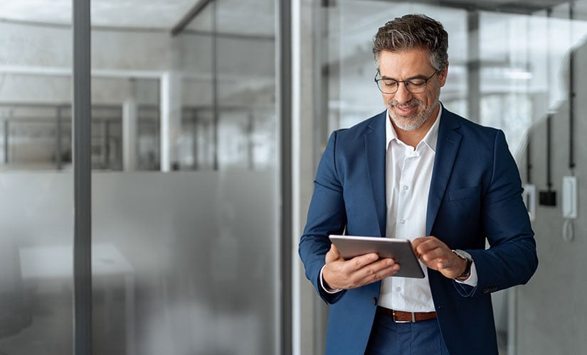 Man using tablet to unlock the power of pre-validated ERP software.
