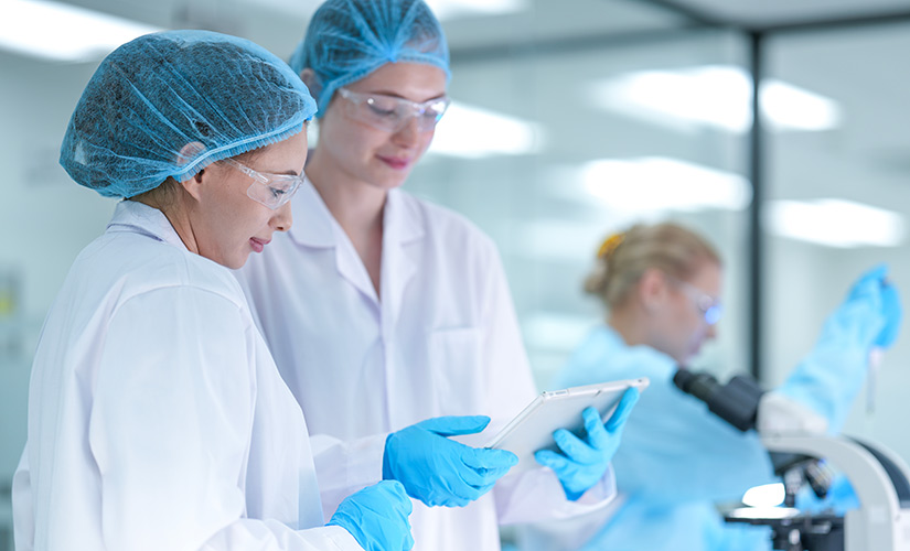 Lab workers holding a tablet learn difference between adverse events and adverse drug reactions and how QT9 QMS can help reporting to FDA and other regulators