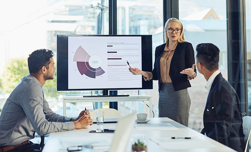 Three business people meeting to discuss the cost of quality.