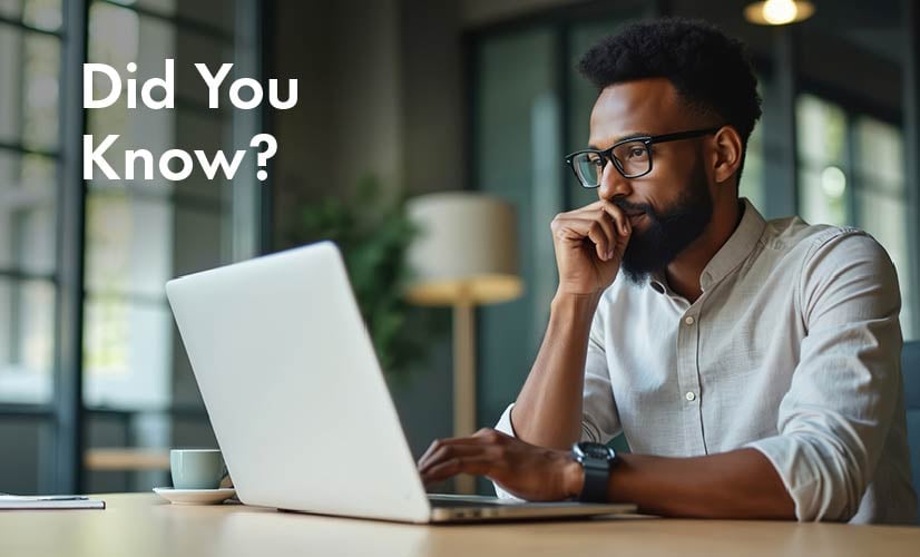 Man sits at desk using laptop with Quality Events management software.