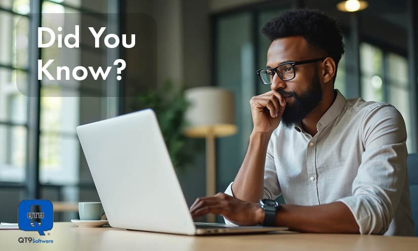 Man with glasses sitting at desk looks at QT9 Software Quality Events applications on laptop.