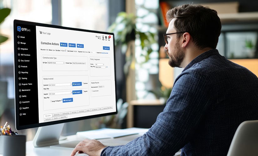 Man looking at computer screen showing QT9 QMS CAPA module, part of the Best QMS for 2026